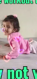 Child in yoga pose with pink hearts on wallpaper.