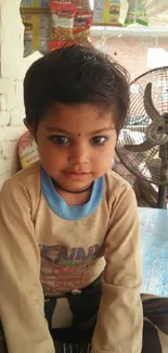 Cute child in a rustic indoor setting with warm tones.