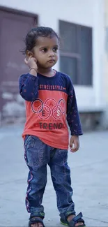 Adorable child in trendy fashion, outdoor setting, charming and stylish portrait.