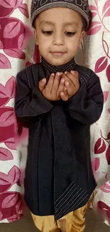 Child in traditional attire with a patterned background.