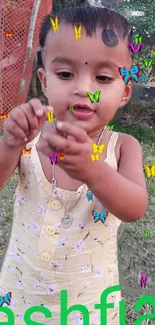 Child playing outdoors with colorful butterfly illustrations.