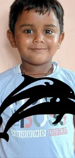 Smiling child wearing blue shirt, with dolphin overlay.