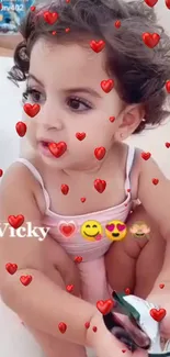 Cute child with curly hair and red heart overlay.