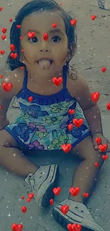 Adorable child with heart overlays on a sandy background.