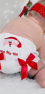 Cute baby in Santa outfit with red bows.