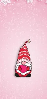 Cute Christmas gnome with heart on pink snowy mobile wallpaper.