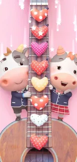 Cartoon cows on a guitar with hearts on pink.