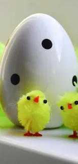 Cute yellow chicks with dotted egg on a shelf.