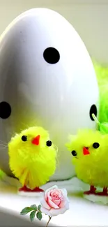 Cute yellow chicks and white egg with pink flower.