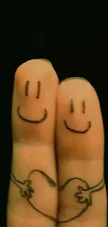 Cute finger art with smiling faces and heart on black background.