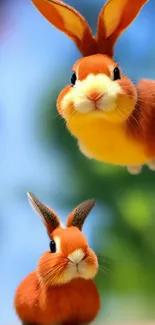 Two fluffy bunnies bouncing playfully against a green and blue backdrop.