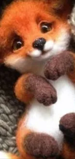 Cute plush fox toy resting on blanket.