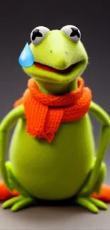 Cute green frog with orange scarf on dark background.