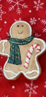 Gingerbread man with scarf on a red snowy backdrop.