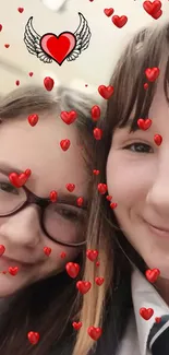 Two friends smiling with heart filter overlay.