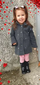 Cute child in grey coat with heart background.