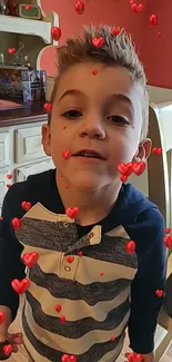 Young boy with playful red hearts floating around.