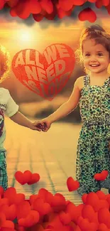 Two kids holding hands with red hearts at sunset.