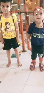 Two cute kids in vibrant outfits indoors.