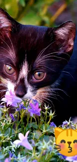 Cute black kitten sniffing purple flowers with a cat emoji.