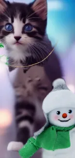 Playful kitten with blue eyes and snowman mobile wallpaper.