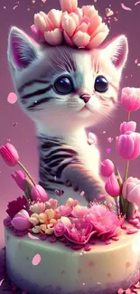 Cute kitten with pink floral cake and heart-shaped petals on wallpaper.