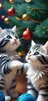 Two fluffy kittens playing near a decorated Christmas tree.