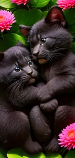 Two black kittens cuddling amidst green leaves and pink flowers, creating a cute scene.