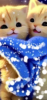 Adorable kittens wrapped in a blue blanket on a snowy background.