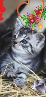 Three cute kittens with colorful floral and heart decorations on hay.