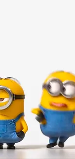 Two lively cartoon minions in blue overalls on white background.