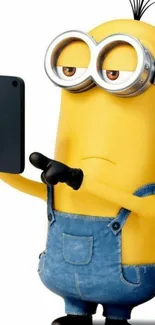 Cute Minion character taking a selfie in denim overalls.