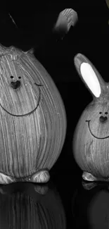 Cute monochrome bunny figures on a black background wallpaper.