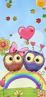 Two cartoon owls on a rainbow with heart balloon and flowers under a sunny sky.