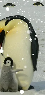 Penguin family in snow with falling snowflakes, capturing a winter wonderland scene.