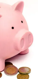 Pink piggy bank with scattered coins on white background.