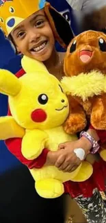 Child hugging Pikachu and Eevee plush toys with a bright smile.