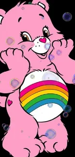 Adorable pink bear with rainbow belly on black background.