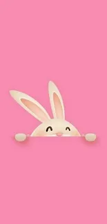 Adorable cartoon bunny peeking over the edge on a pink background.