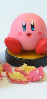 Cute Kirby figure with cake pieces on a mobile wallpaper.