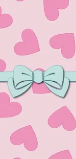 Pastel pink wallpaper with hearts and a blue bow for phones.