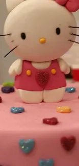 Cartoon kitten atop a pink cake with colorful hearts.