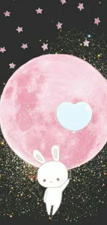 Cute bunny holding a balloon with pink moon backdrop.