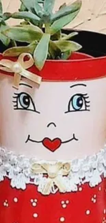 Charming plant pot with a cute face and red accents.