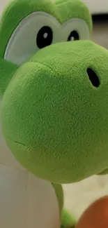 Green plush dinosaur toy with large eyes on a soft background.