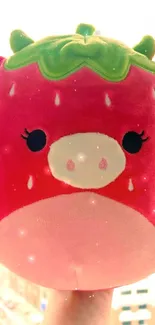 Adorable plush strawberry toy on background.