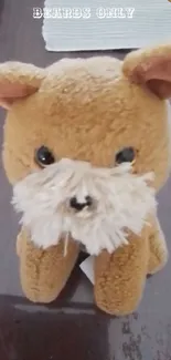 Plush toy dog with fluffy beard on a table.