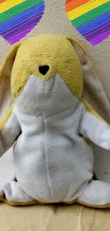 Cute plush bunny with rainbow hearts wallpaper.