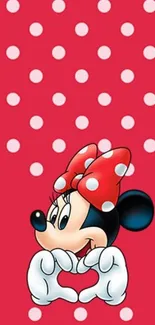 Beloved character with red polka dots and a bow on a vibrant wallpaper.