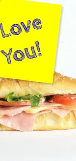 Sandwich with yellow love note on white background.